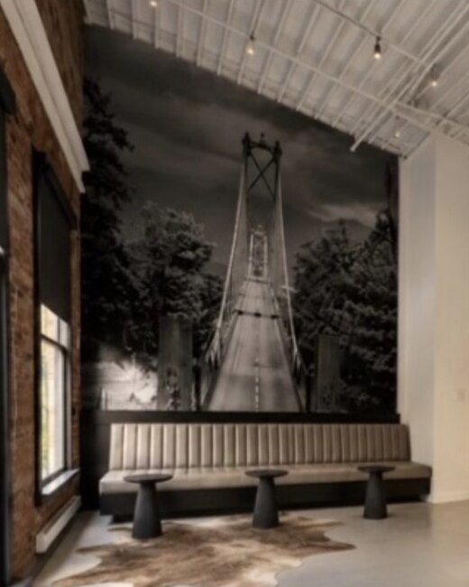 The client lounge: a long banquette under a photograph of a bridge