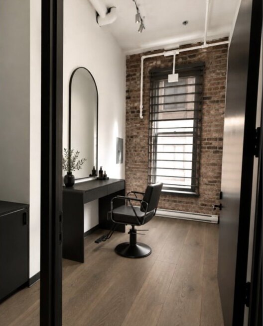 The styling suite: a chair, a mirror and a brick wall